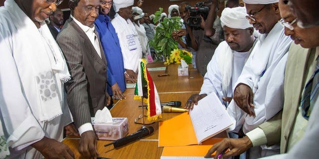 Government officials (left) with leaders of the Abbala and Beni Hussein tribes in El Fasher, N.Darfur, last week. Fighting between rival Arab tribes in Sudan's Darfur region spread on Monday, after clashes last week left scores dead, a leader of one of the tribes said.