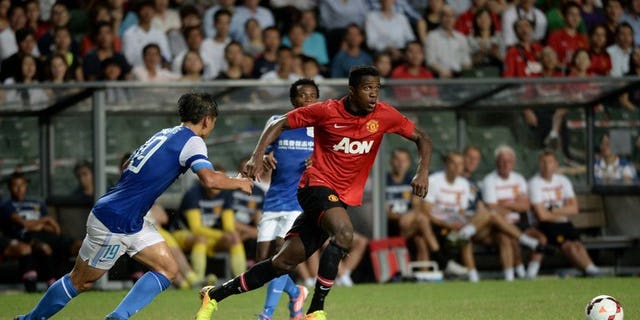Danny Welbeck (right) of Manchester United runs for the ball against Hong Kong team Kitchee players during their friendly match at Hong Kong stadium on July 29, 2013. Manchester United saw off a spirited Kitchee 5-2 on Monday in Hong Kong to give David Moyes just his second victory as manager of the Premier League champions.