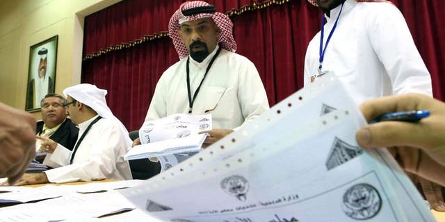 Kuwaiti judges and their aides count the ballots at a polling station after closure of voting in al-Khaldeyya district of Kuwait city, on July 27, 2013. Kuwait's Emir Sheikh Sabah al-Ahmad Al-Sabah on Monday asked the outgoing prime minister to form a new government following polls, the official KUNA news agency reported.