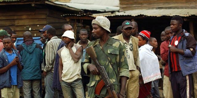 A M23 soldier stands guard in the village of Kimbuba, in a M23 rebel-held territory, in the Democratic Republic of Congo on July 25, 2013. The United Nations on Tuesday gave M23 rebel forces 48 hours to leave the city of Goma in the eastern Democratic Republic of Congo or face "the use of force."