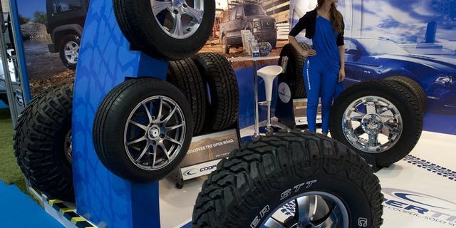 Cooper tyres are exhibited at a motor show in Santiago, on October 4, 2012. More than 5,000 Chinese workers at a Sino-US joint venture tyre manufacturer for Cooper Tireand Rubber have gone on strike against the American parent company's $2.5 billion takeover by an Indian firm, state media reported.