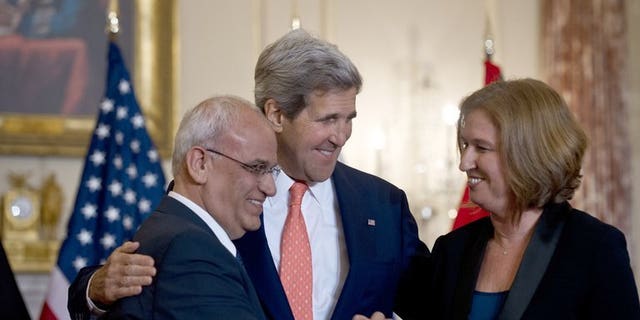 US Secretary of State John Kerry (centre) with chief Palestinian negotiator Saeb Erakat (left) and Israel's Justice Minister Tzipi Livni at the State Department in Washington, on July 30, 2013. Israeli and Palestinian negotiators' stated goal of reaching a comprehensive peace deal inside nine months is realistic, according to the European Union's top diplomat.