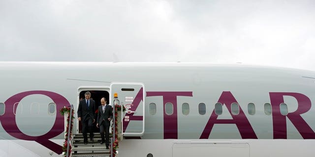 Boeing CEO Ray Conner (left) and Qatar Airways CEO Akbar Al Baker on a Dreamliner at Farnborough in July 2012. A Qatar Airways Boeing 787 Dreamliner resumed flights on Wednesday after being grounded for several days because "technical components required replacement," the company said.
