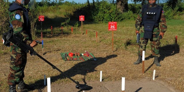 Cambodian soldiers scan for mines in Oudong, some 40 kilometers north of Phnom Penh, on November 27, 2011. Two Cambodian children and a man were killed when their buffalo cart hit an anti-tank mine left over from the country's civil war, police tell AFP.