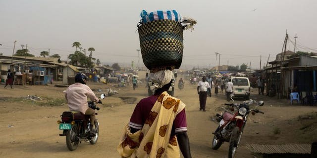 A woman walks through Gudele market in Juba, South Sudan. Two Ugandan journalists were freed in South Sudan on Wednesday after four nights in detention for filming in the capital Juba, the reporters said.