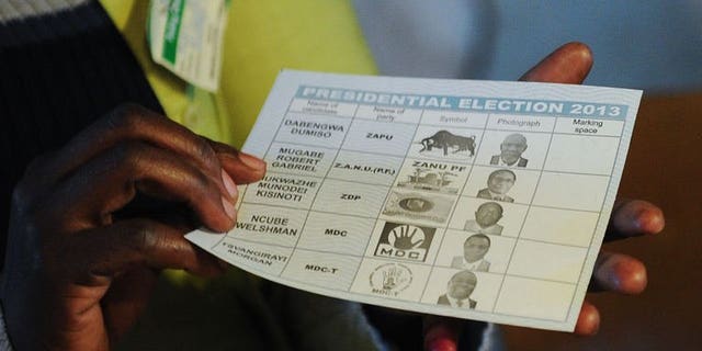 A Zimbabwean holds up a ballot at a polling station in Domboshava, north of Harare, on July 31, 2013, during the general election. The African Union's top poll observer said Zimbabwe's crunch presidential election Wednesday appeared, according to initial reports, to have passed off smoothly.