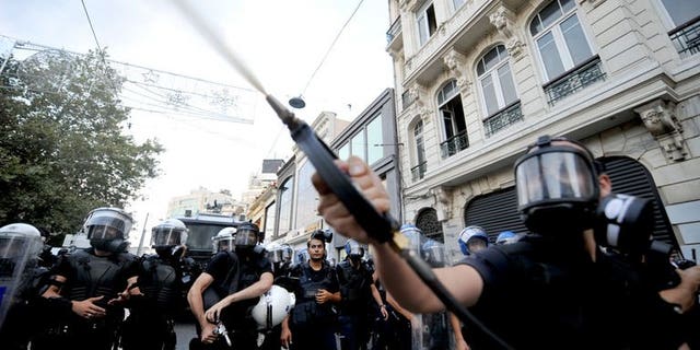 Turkish riot policemen use tear gas to disperse anti-goverment protestors during a demonstration at Taksim Square on July 31, 2013 in Istanbul.