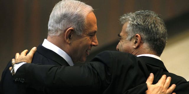 Israeli Prime Minister Benjamin Netanyahu (L) and Yair Lapid, during a parliament session on March 18, 2013 in Jerusalem. Economist Leo Leiderman was named Israel's central banker on Wednesday, days after the previous candidate pulled out after an investigation against him on a shoplifting allegation.