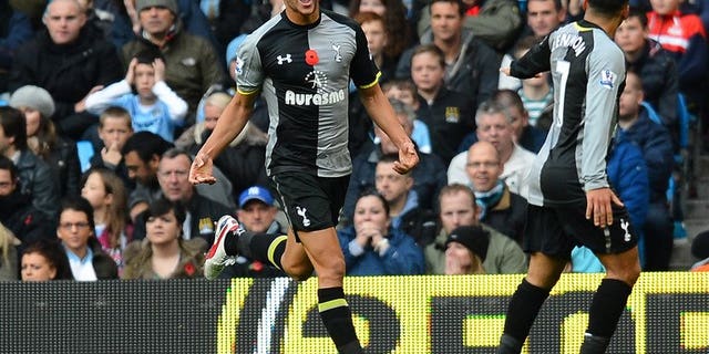 Tottenham Hotspur's English defender Steven Caulker (L) celebrates after scoring at The Etihad stadium in Manchester, north-west England on November 11, 2012. English Premier League newboys Cardiff on Wednesday signed Caulker for a club record fee believed to be in excess of eight million pounds ($12.1million), the BBC reported.