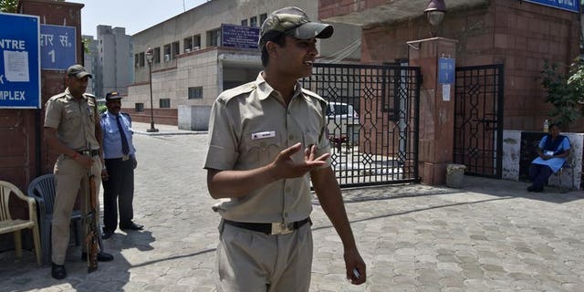 Indian police-men stand guard outside the Saket district court in New Delhi on April 8, 2013. The new police chief of India's capital said Wednesday his top priority was making the city safer for women after the fatal gang-rape of a student sparked violent protests.