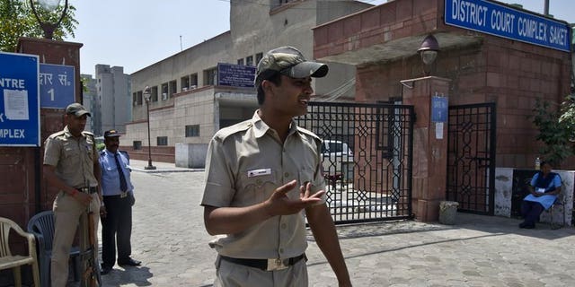 Indian police-men stand guard outside the Saket district court in New Delhi on April 8, 2013. The new police chief of India's capital said Wednesday his top priority was making the city safer for women after the fatal gang-rape of a student sparked violent protests.