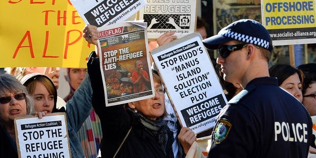 People protest against the Australian government's new policy of resettling refugees in Papua New Guinea, in Sydney on July 22, 2013.