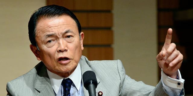 Japanese Finance and Deputy Prime Minister Taro Aso talks to the media in Tokyo, June 28, 2013. The gaffe-prone Aso has retracted controversial remarks that suggested Tokyo could learn from Nazi Germany when it comes to constitutional reform.