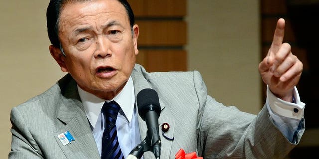 Japanese Finance and Deputy Prime Minister Taro Aso talks to the media in Tokyo, June 28, 2013. The gaffe-prone Aso has retracted controversial remarks that suggested Tokyo could learn from Nazi Germany when it comes to constitutional reform.