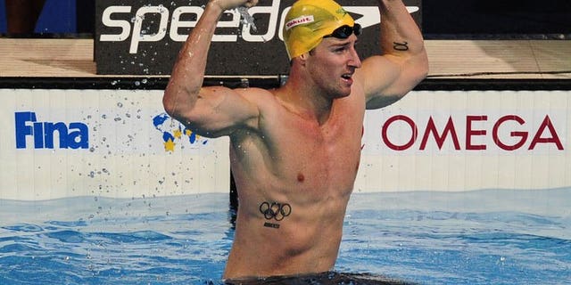 Australia's James Magnussen celebrates after winning the final of the men's 100-metre freestyle swimming event in the FINA World Championships at Palau Sant Jordi in Barcelona on August 1, 2013.