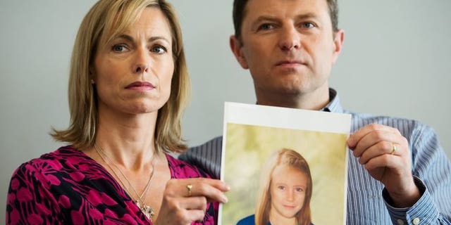 The parents of Madeleine McCann, Kate (L) and Gerry McCann (R), pose with an artist's impression of how their daughter might look now at the age of nine, in London on May 2, 2012. Portuguese authorities on Thursday accepted a request from Britain to work with detectives who have reopened the investigation into the disappearance of the British girl in 2007.