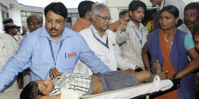 A child, who fell ill from the drinking water at his school, is brought to the Patna Medical College and Hospital in Patna on August 1, 2013. About a dozen children fell ill and were taken to hospital after drinking suspected contaminated water at their school in eastern India, a hospital official said.