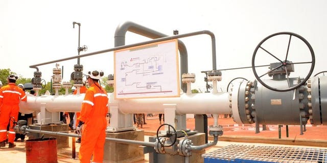 Technicians work next to an oil pipeline on June 9, 2013 in Badila, southern Chad. TransCanada announced plans for the construction of a $12 billion pipeline to carry oil from the Alberta oil sands to the Atlantic seaboard.