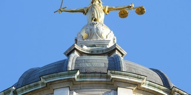 The statue of justice, on the roof of the Old Bailey, pictured on December 17, 2003 in London. Ten men accused of sexually exploiting teenage girls have been charged with offences including rape, sexual assault and trafficking, police said Friday.