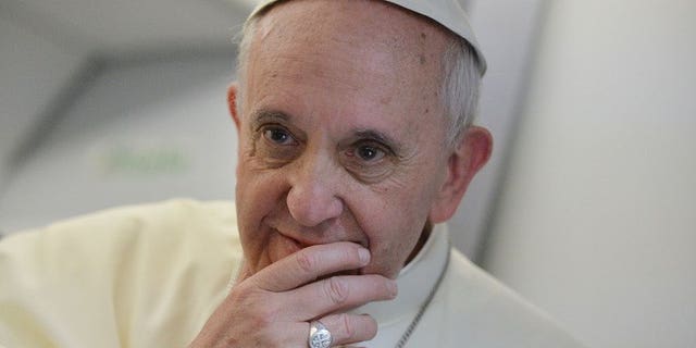 Pope Francis listens to a question during a press conference held aboard the papal flight on July 28, 2013. The pontiff has called for "mutual respect" between Christianity and Islam and an end to "unfair criticism" in a personal message congratulating Muslims on the feast of Eid al-Fitr.
