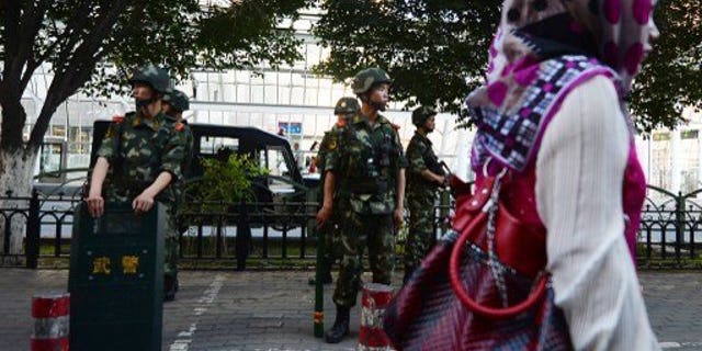 Chinese paramilitary police stand guard in the Muslim Uighur minority area of Urumqi, Xinjiang Province on June 30, 2013. Human rights conditions in China are worsening, a senior US official said Friday, accusing Beijing of harassing activists' family members and repressing ethnic and religious minorities.