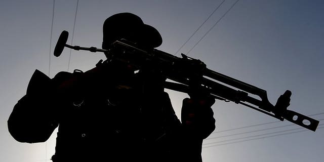 An Afghan policeman keeps watch at a checkpoint in Kabul. on July 19, 2010. More than 20 Afghan policemen and dozens of Taliban insurgents were killed when hundreds of fighters ambushed a police and military convoy in eastern Afghanistan.