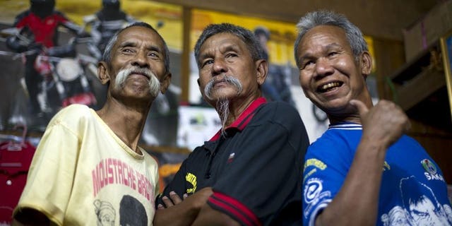 This picture taken on February 24, 2012 shows the 'Moustache Brothers', Lu Maw (L), Par Par Lay (C) and Lu Zaw, in Mandalay, Myanmar. Par Par Lay, 67, died at home on Friday shortly after he was released from hospital where he was taken with a kidney disease.