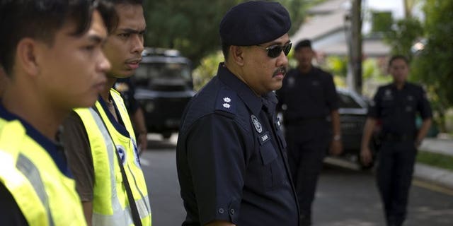 Malaysian police officers pictured during a road block in downtown Kuala Lumpur on March 16, 2012. Six family members who suffocated a Malaysian toddler to death by piling on top of her for hours in a suspected exorcism ritual have been fined but avoided jail, a report said Saturday.