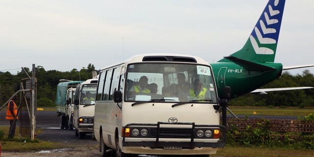 Image taken by the Australian Government Department of Immigration and Citizenship on August 1, 2013 shows asylum-seekers being transported in buses after arriving in PNG. Australia expanded its plan banishing asylum-seekers arriving by boat to PNG Saturday to include Nauru island as national elections loom.