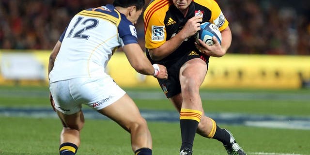 Chiefs Toby Smith is tackled by Brumbies Christian Lealiifano during their Super 15 rugby final match in Hamilton, New Zealand on August 03, 2013. The Waikato Chiefs came from behind to beat the ACT Brumbies 27-11 in the match, to reinforce their standing as the southern hemisphere rugby powerhouse.