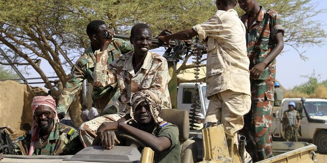 Sudanese soldiers keep watch in the Shangil Tobaya area for displaced people in North Darfur state, on June 18, 2013. A new outbreak of tribal violence in Darfur region has killed nine people, official media said, in fighting that has added to worsening insecurity in the region.