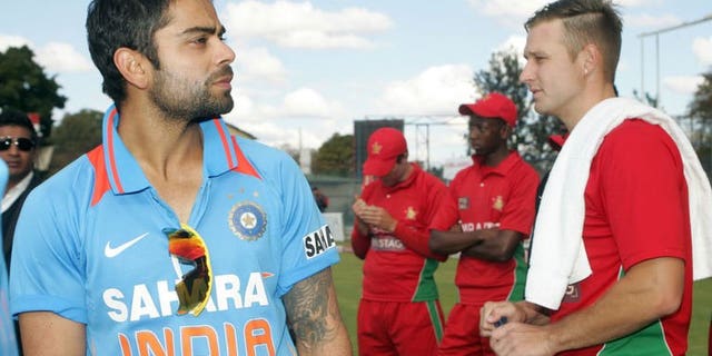 India captain Virat Kohli (L) stands with Zimbabwe bowler Kyle Jarvis at Queens Sports Club in Harare on August 3, 2013. Kohli believes that his young team will take plenty away from their 5-0 series sweep in Zimbabwe, despite the home side's inability to provide any meaningful challenge.