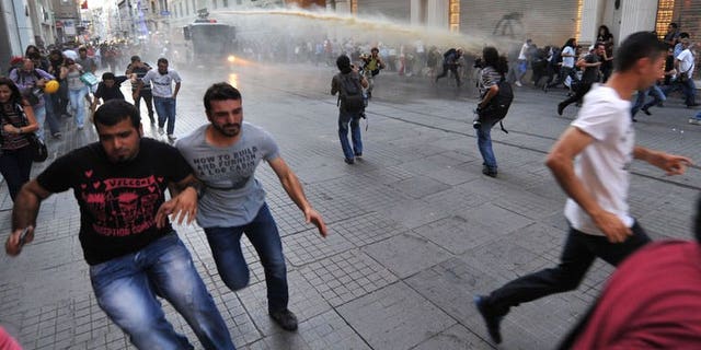 Turkish riot police use water cannon to disperse anti-goverment protestors during clashes at Istiklal street on August 3, 2013 in Istanbul.