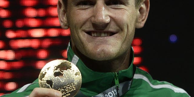 Gold medalist South Africa's Cameron Van Der Burgh poses on the podium with his medal during the award ceremony of the men's 50m breaststroke event in the FINA World Championships at Palau Sant Jordi in Barcelona, on July 31, 2013. He contracted COVID-19 and described the illness as “by far the worst virus I have ever endured.”<br data-cke-eol="1">