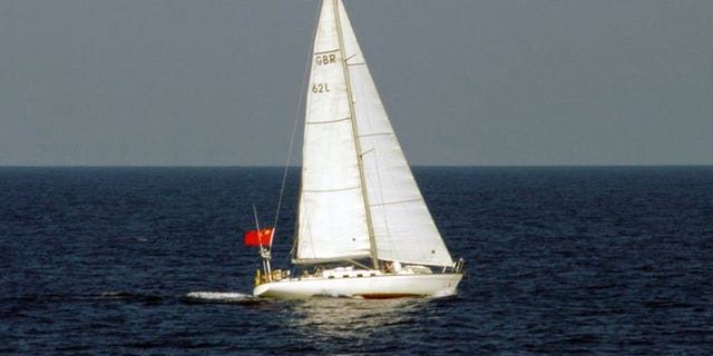 This photo, taken by Japan Coast Guard on August 3, 2013, shows a yacht of British registry carrying a Chinese flag as it cruises near the disputed islets known as the Senkaku islands in Japan and Diaoyu islands in China, in the East China Sea. The yacht entered Japan's territorial waters and sailers of the yacht threw a buoy with a red flag into the water and left the area.