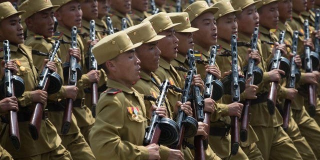 North Korean soldiers march through Kim Il-Sung square during a military parade, marking the 60th anniversary of the Korean war armistice, in Pyongyang, on July 27, 2013. N.Korea has cut short summer military drills to mobilise troops for flood relief efforts after torrential rains left dozens killed and ravaged farmlands nationwide, according to a S.Korean report.