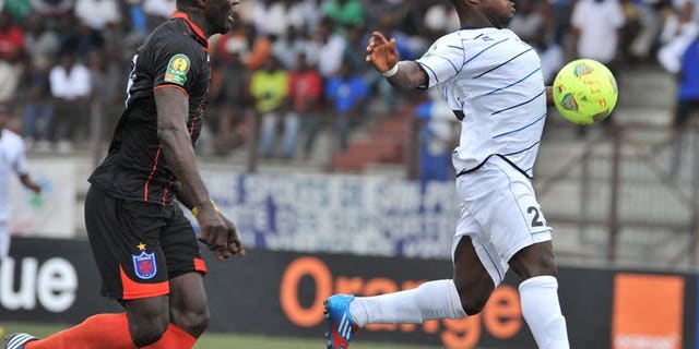 Ivory Coast's Sewe player Kevin Zougoula (right) vies for the ball with Recreativo Libolo of Angola player Edy Nycolas-Boyom during their African Champions league match at the Robert Champroux stadium in Abidjan on August 3, 2013. Zougoula scored a CAF Champions League hat-trick this weekend as Ivory Coast club Sewe San Pedro made a winning Group B debut.