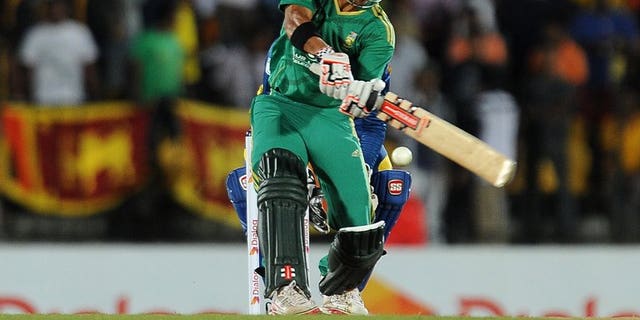 South African batsman JP Duminy plays a shot during the Twenty20 match against Sri Lanka in the district of Hambantota on August 4,2013. South Africa's captain Faf du Plessis won the toss and chose to bat in windy conditions in the second Twenty20 international against Sri Lanka in Hambantota
