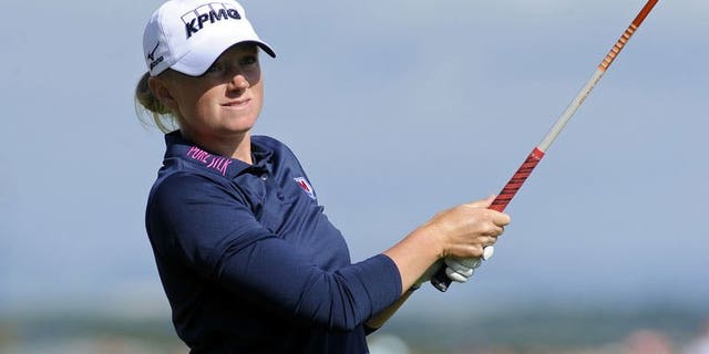 US golfer Stacy Lewis watches her tee shot from the 17th tee during the completion of the delayed third round of the Women's British Open Golf Championship at the Old Course in St Andrews, Scotland, on August 4, 2013. Lewis won by two shots.
