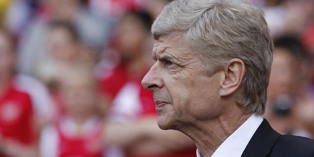 Arsenal's French manager Arsene Wenger looks on ahead of the pre-season friendly football match between Arsenal and Galatasaray at The Emirates Stadium in north London on August 4, 2013. Wenger admits Arsenal may be forced to go into their crucial Champions League qualifier without further additions to the squad.