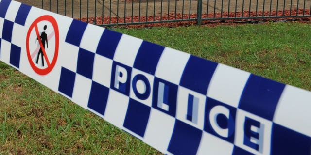 This file illustration photo shows a police tape cordoning off a crime scene near Sydney, in 2011. A two-year-old boy was mauled to death at his grandmother's house in a savage attack by a mastiff cross dog, Sunday afternoon at Deniliquin, in southwestern New South Wales.