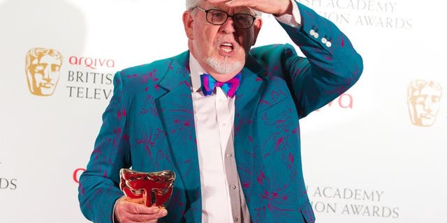 Winner of the Bafta Fellowship award, Australian entertainer Rolf Harris poses in front of the winners boards at the British Academy Television Awards at the Royal Festival Hall in London, on May 27, 2012. Harris was re-arrested by police in Britain on Monday over further allegations of sexual offences.