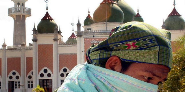 A Thai Muslim walks by the Pattani Central mosque during a demonstration in the restive Pattani province on June 4, 2007. A Muslim leader seen as a major figure in efforts to end a bloody insurgency in Thailand's south was shot dead Monday, raising concern about the future of peace talks.