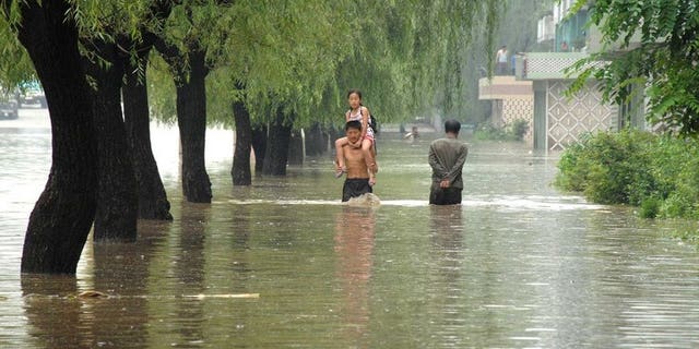 This file photo, taken by North Korea's official Korean Central News Agency in July, 2012, shows a road and houses being flooded at Anju city in South Phongan province, caused by typhoon and heavy downpour. Decades of deforestation and decrepit infrastructure have left N.Korea particularly vulnerable to floods, which led to some 170 deaths last summer.