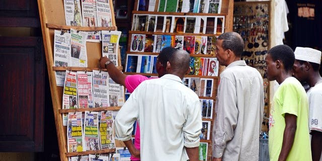 Local people look at a newspaper stand in Stone Town in Zanzibar on January 7. Journalists in Tanzania face increasing threats and lack government protection, with at least ten attacks against the media in the past year, the Committee to Protect Journalists said Tuesday.
