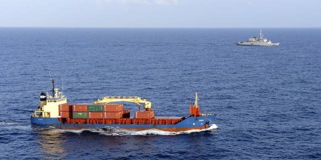 A cargo ship carrying sensitive cargo is escorted by a French military frigate in the Gulf of Aden on January 11, 2009. Britain has issued the highest possible security alert to British shipping companies operating off the coast of Yemen, an expert said on Tuesday, amid a worldwide terror alert focused on the country.