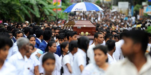 Sri Lankan students carry the coffin of their colleague, Akila Dinesh Jayawardena who was shot dead during an army crackdown against people protesting tainted ground water in the village of Weliweriya on August 4, 2013. Sri Lanka's opposition Tuesday demanded an international investigation into a deadly army crackdown on villagers who were demonstrating against contaminated water supplies.