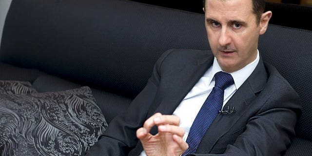 A handout picture released by the Syrian Arab News Agency (SANA) on June 17, 2013, shows Syrian President Bashar al-Assad speaking during an interview with the Frankfurter Allgemeine Zeitung newspaper in Damascus. Assad has passed a decree legalising private security firms, faced with a 29-month armed revolt against his rule that has pinned down the police, according to the SANA news agency.