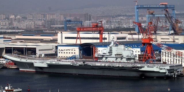 China's first aircraft carrier, the "Liaoning" sits berthed at the naval base in Dalian, northeast China's Liaoning province on September 25, 2012. No-one can contain China's rise, a leading Beijing foreign policy thinker said Tuesday, warning Manila and Tokyo that they had been mistakenly emboldened by Washington in territorial disputes with his country.