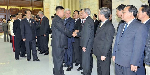 This undated photo released by North Korea's official Korean Central News Agency (KCNA) on July 28, 2013 shows North Korean leader Kim Jong-Un (centre L) welcoming head of the International Department of the Central Committee of the Communist Party of Cuba Jose Ramon Balaguer (centre R) in Pyongyang. Cuba said it was looking forward to closer cooperation with North Korea after "favorable" talks.